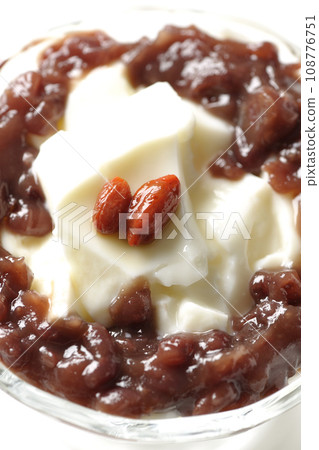 An overhead shot of plenty of red bean paste and almond tofu served in a dessert cup against a white background An overhead shot of plenty of red bean paste and almond tofu served in a dessert cup against a white background 108776751