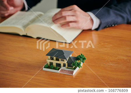 A male lawyer researches the problem of empty houses in his parents' home by looking at the complete set of six law books. 108776809