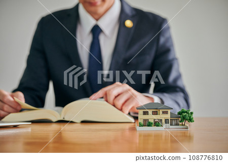 A male lawyer researches the problem of empty houses in his parents' home by looking at the complete set of six law books. 108776810