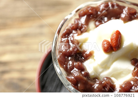An overhead shot of plenty of red bean paste and almond tofu served in a dessert cup An overhead shot of plenty of red bean paste and almond tofu served in a dessert cup 108776921