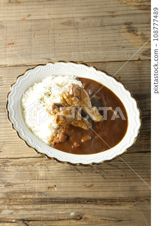 An overhead shot of hot curry rice with bone-in chicken An overhead shot of hot curry rice with bone-in chicken 108777489