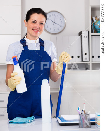 woman cleaning the office with cleaners, gloves and mop 108777828