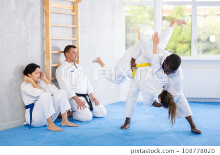 Adult man and adult woman train judo techniques Adult man and adult woman train judo techniques 108778020