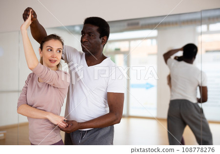 Man and woman training pair dance in studio Man and woman training pair dance in studio 108778276
