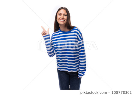 young stylish woman with straight hair is dressed in a loose-fitting striped sweater on a white 108778361