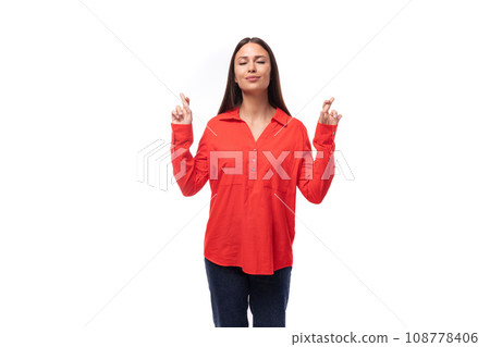 young calm brunette caucasian model woman dressed in a fashionable red shirt crossed her fingers on young calm brunette caucasian model woman dressed in a fashionable red shirt crossed her fingers on 108778406