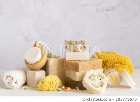 Natural handmade soap bars, towel, natural sponges and brushes on marble close up 108779670