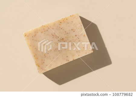 Natural herbal beige soap bar on light beige top view, hard shadows Natural herbal beige soap bar on light beige top view, hard shadows 108779682