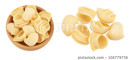 lumaconi pasta in wooden bowl isolated on white background with full depth of field. Top view. Flat lay lumaconi pasta in wooden bowl isolated on white background with full depth of field. Top view. Flat lay 108779736
