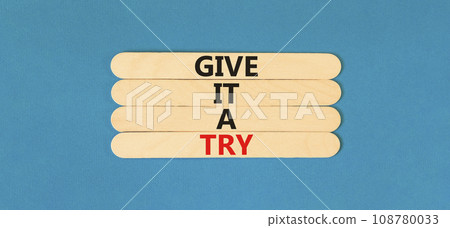 Give it a try symbol. Concept word Give it a try on beautiful wooden stick. Beautiful blue table blue background. Business give it a try concept. Copy space. 108780033