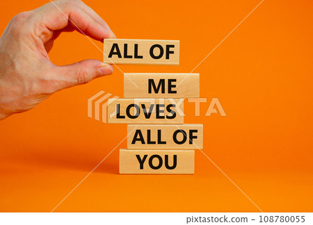 All of me loves all of you symbol. Wooden blocks with words All of me loves all of you on beautiful orange background, copy space. Businessman hand. Lifestyle, love concept. 108780055