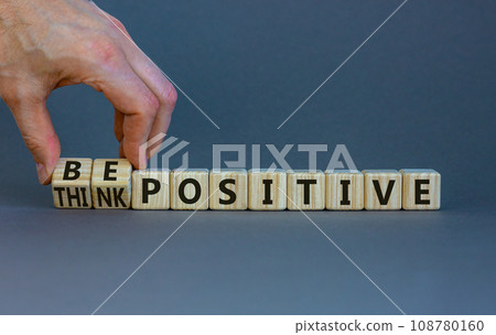 Think and be positive symbol. Businessman turns wooden cubes and changes words think positive to be positive. Beautiful grey background. Business, think and be positive concept. Copy space. 108780160