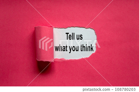 The text 'tell us what you think' appearing behind torn pink paper. The text 'tell us what you think' appearing behind torn pink paper. 108780203