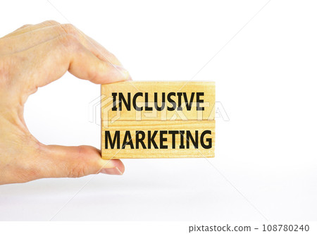 Inclusive marketing symbol. Concept words Inclusive marketing on beautiful wooden block. Beautiful white table white background. Businessman hand. Business inclusive marketing concept. Copy space. Inclusive marketing symbol. Concept words Inclusive marketing on beautiful wooden block. Beautiful white table white background. Businessman hand. Business inclusive marketing concept. Copy space. 108780240
