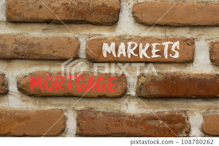 Mortgage markets symbol. Concept words Mortgage markets on beautiful brown brick wall. Beautiful brown brick wall background. Business mortgage markets concept. Copy space. 108780262