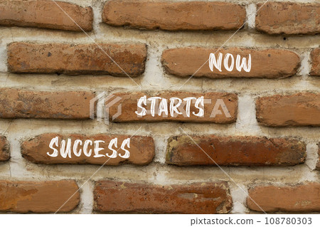 Success starts now symbol. Concept word Success starts now on beautiful red brown bricks. Beautiful red brown brickwall background. Business motivational success starts now concept. Copy space. 108780303