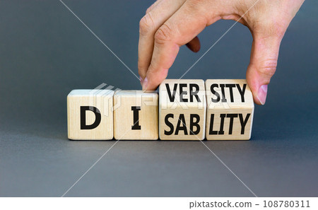 DEI Diversity or disability symbol. Concept words Diversity disability on wooden block. Beautiful grey table grey background. Businessman hand. Business diversity disability concept. Copy space. DEI Diversity or disability symbol. Concept words Diversity disability on wooden block. Beautiful grey table grey background. Businessman hand. Business diversity disability concept. Copy space. 108780311