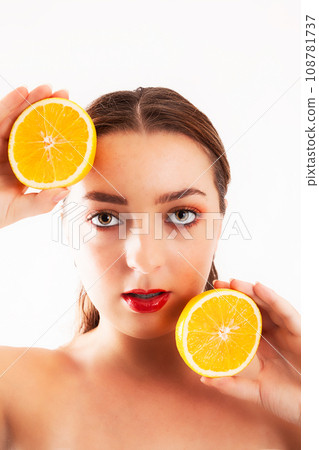 Young woman with orange halves in her Young woman with orange halves in her 108781737