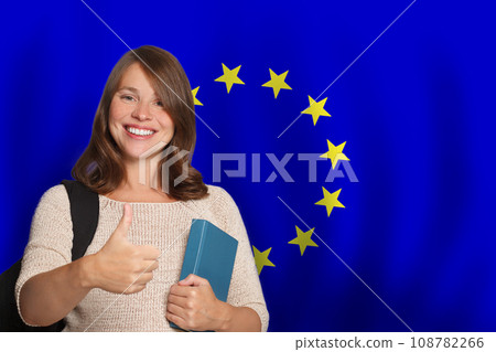 Attractive woman student against European Union flag background. Travel and education concept 108782266