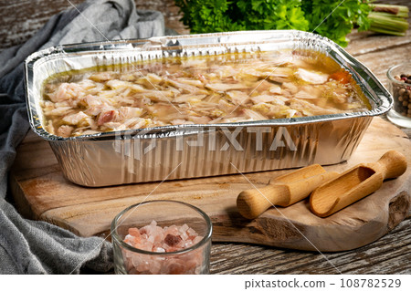 Jelly with shredded chicken meat in a mold. Jelly with shredded chicken meat in a mold. 108782529