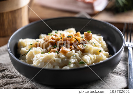 Halusky as traditional Slovak potato gnocchi with sheep cheese bryndza, fried bacon and chives Halusky as traditional Slovak potato gnocchi with sheep cheese bryndza, fried bacon and chives 108782601