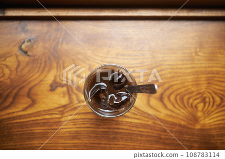 Glass of Vietnamese iced coffee on wooden table 108783114