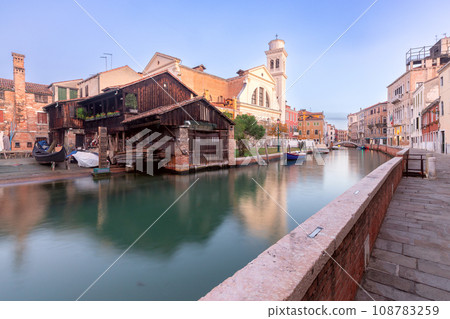 An old boat and gondola repair shop on the banks of a canal in Venice. An old boat and gondola repair shop on the banks of a canal in Venice. 108783259