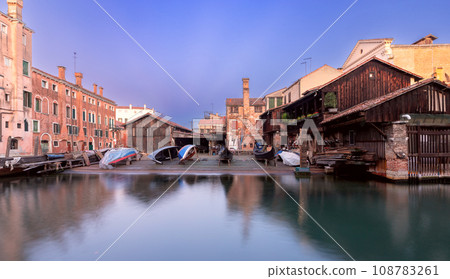 An old boat and gondola repair shop on the banks of a canal in Venice. 108783261