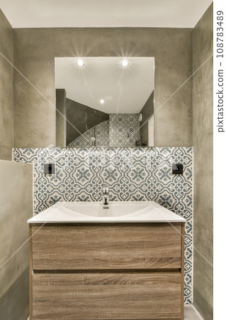 a bathroom with a sink and mirror in the corner, as seen from the top down to the floor below 108783489