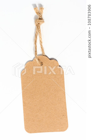 Blank brown rectangular brown paper tag on a rope  on white background, template for price, discount 108783906
