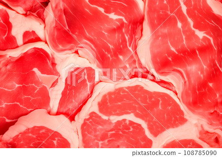 Macro closeup view of a red piece of veal meat on table. Slices of beef steak with a red streaked texture 108785090
