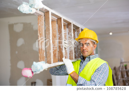 Young foreman carries a stepladder 108785628