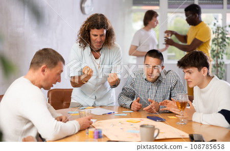 Group of men play board games 108785658