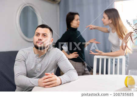 Man waiting for two women stop quarreling Man waiting for two women stop quarreling 108785685