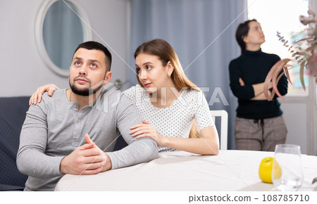 Woman comforting man during quarrel with friend 108785710