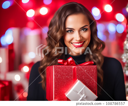 smiling woman with christmas gift smiling woman with christmas gift 108786557
