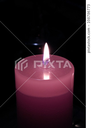 pink candle flame emerging in the darkness pink candle flame emerging in the darkness 108786773
