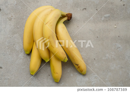 Ripe bananas bunch on the concrete background 108787389