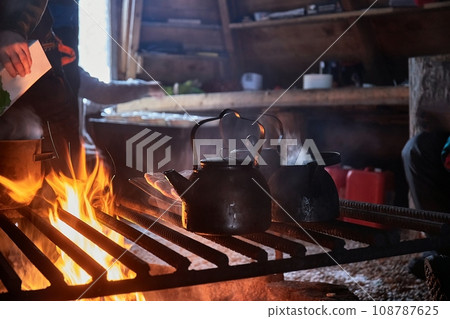 Flames of a fireplace wood fire in refuge hut 108787625