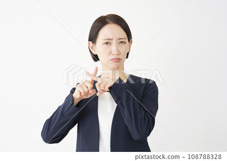 Middle-aged business woman making a cross-mark gesture with her finger, white background Middle-aged business woman making a cross-mark gesture with her finger, white background 108788328