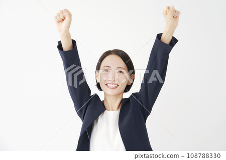 Middle-aged business woman fist-pumping white background Middle-aged business woman fist-pumping white background 108788330