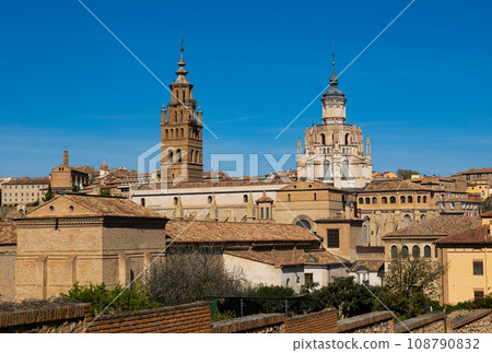 Bell tower and dome of Tarazona Cathedral rising above residential buildings 108790832