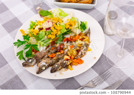 Appetizing fried blue whiting with vegetables 108790944