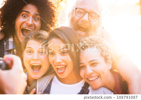 Joyful Unity: Multiracial Friends Enjoying Nature Together being photographed Joyful Unity: Multiracial Friends Enjoying Nature Together being photographed 108791087