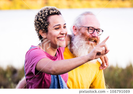 Ageless Joy: Diverse Couple's Nature Walk Ageless Joy: Diverse Couple's Nature Walk 108791089