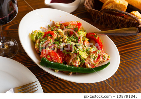 Plate with vegetable salad with tomatoes and cucumber Plate with vegetable salad with tomatoes and cucumber 108791843