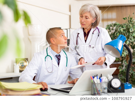 Two doctors in office at work 108791927