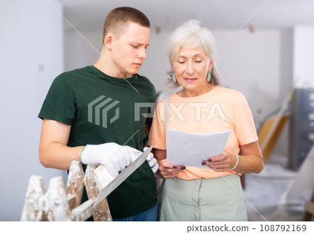 Woman talking with teenager on construction site 108792169