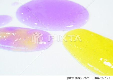 Beautiful mixed yellow and purple slime with glitter on a white background Beautiful mixed yellow and purple slime with glitter on a white background 108792575