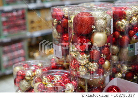 Christmas ornaments. Christmas market store - Colorful decorations red and golden balls in boxes Christmas ornaments. Christmas market store - Colorful decorations red and golden balls in boxes 108793337